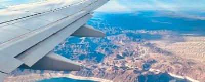 Photo looking out a plane window over a wing.